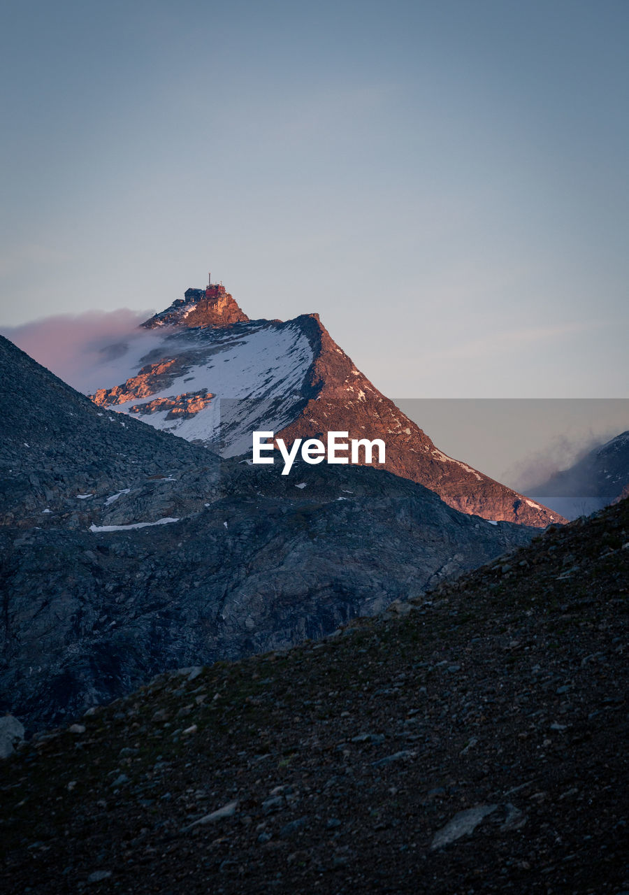 Low angle view of snowcapped mountain against sky