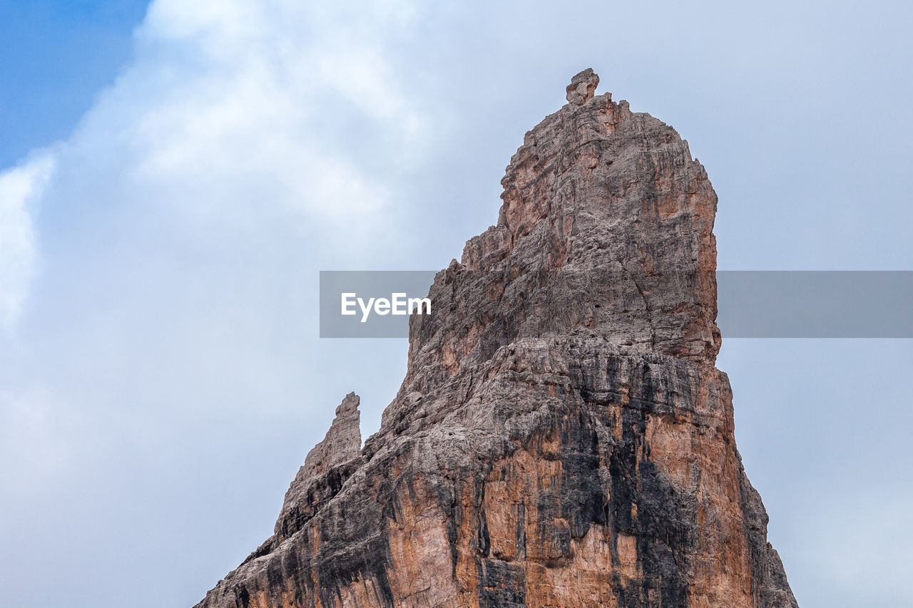 Low angle view of rock formation on mountain against sky