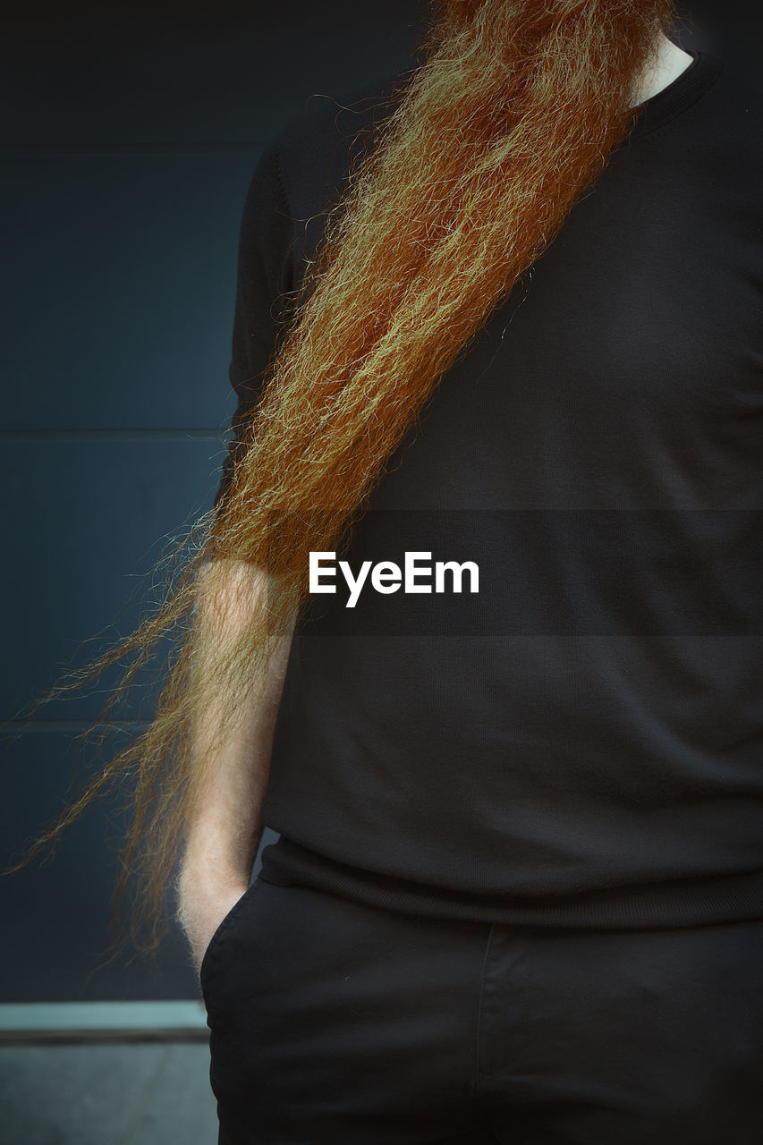 REAR VIEW OF WOMAN WITH HANDS IN BACKGROUND