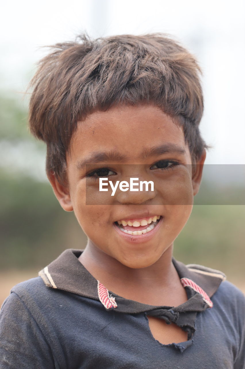 CLOSE-UP PORTRAIT OF SMILING BOY