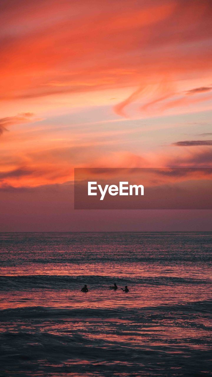 Scenic view of sea against romantic sky at sunset