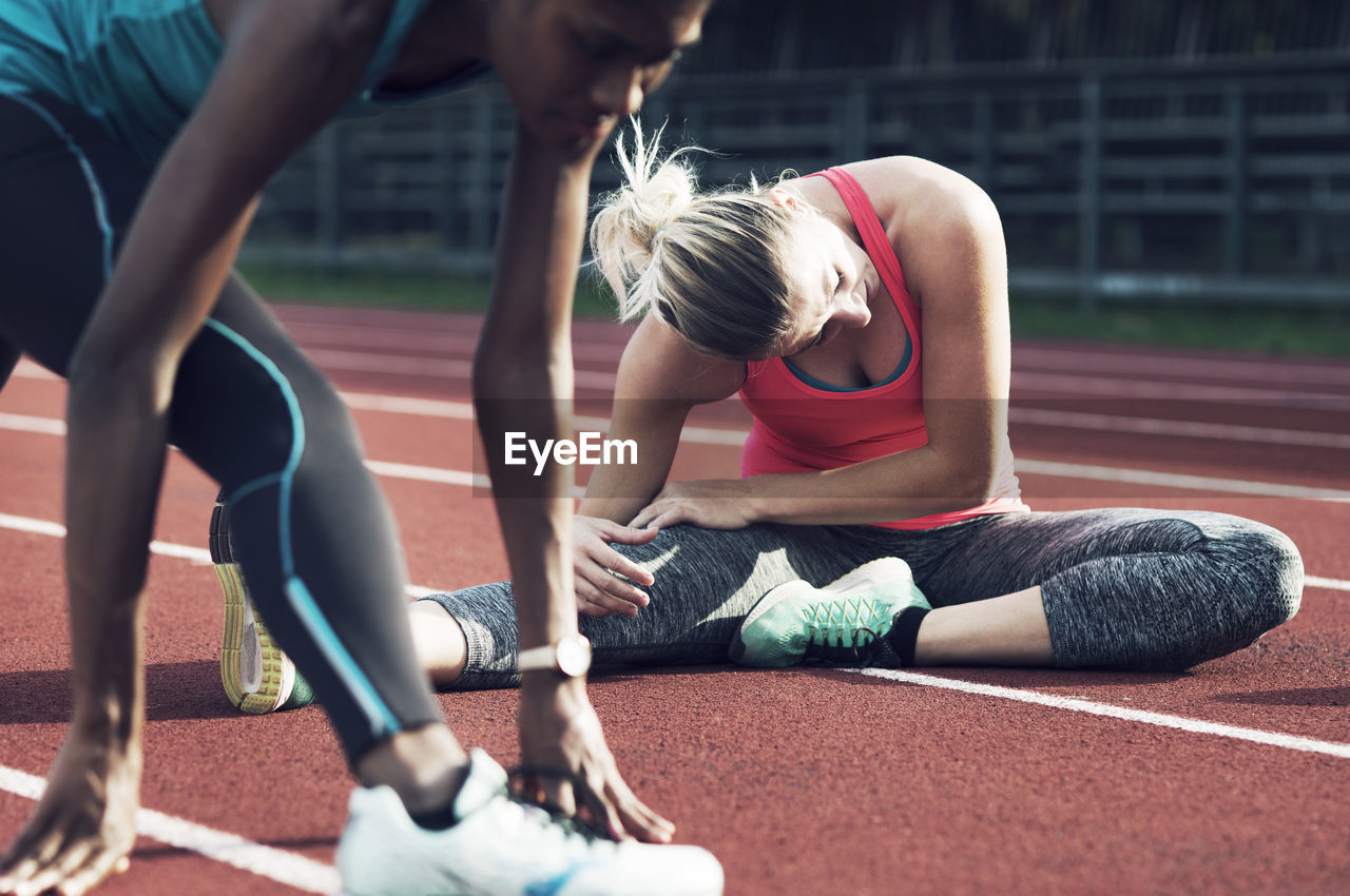 Female athletes exercising on track