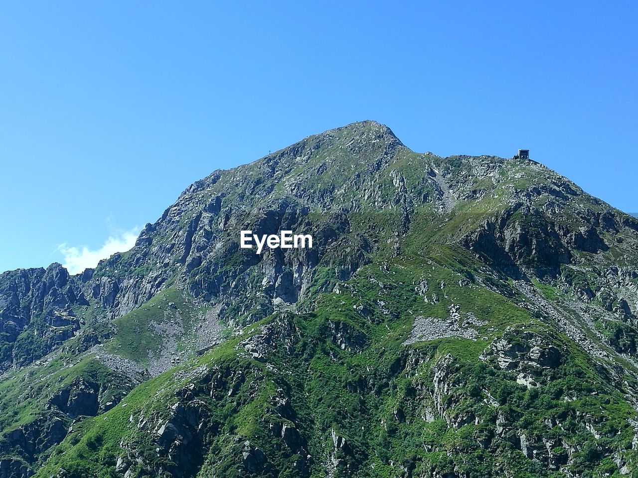 Low angle view of mountain against clear blue sky