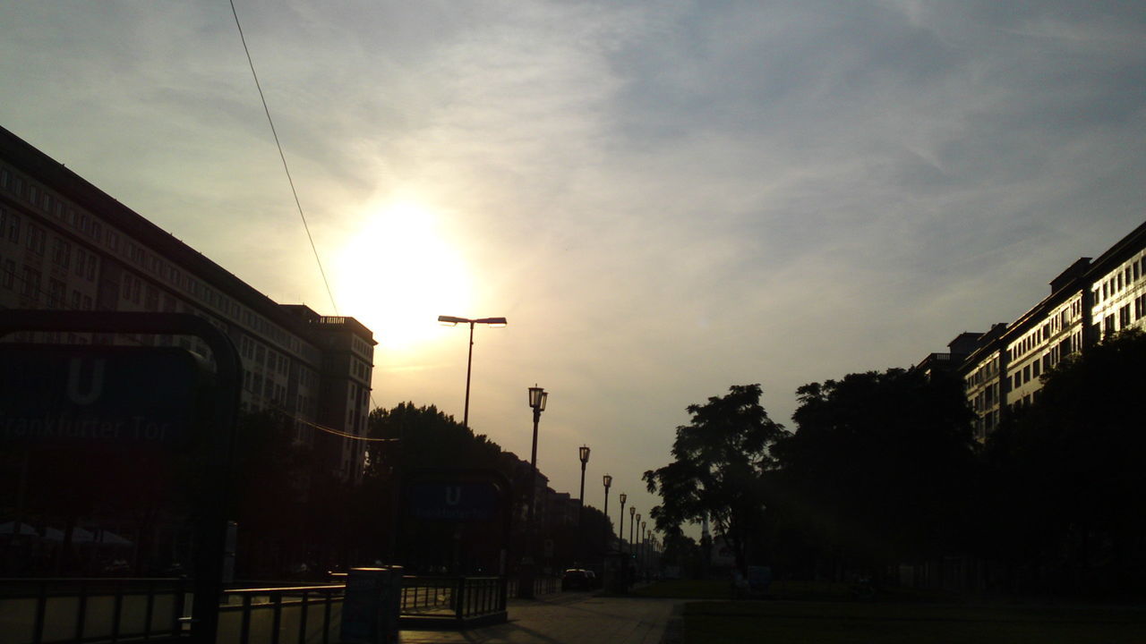 LOW ANGLE VIEW OF BUILDINGS AGAINST SKY AT SUNSET