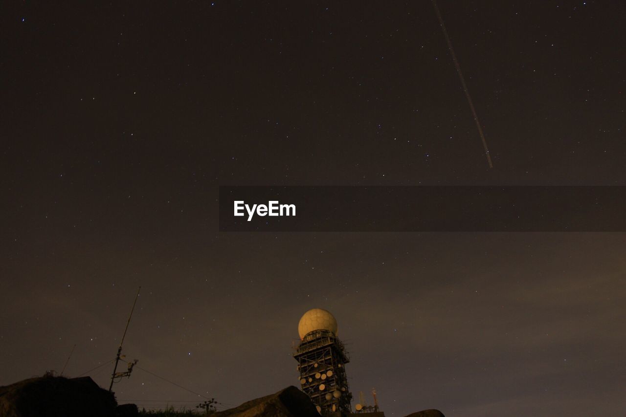 Low angle view of communication tower with satellite dish