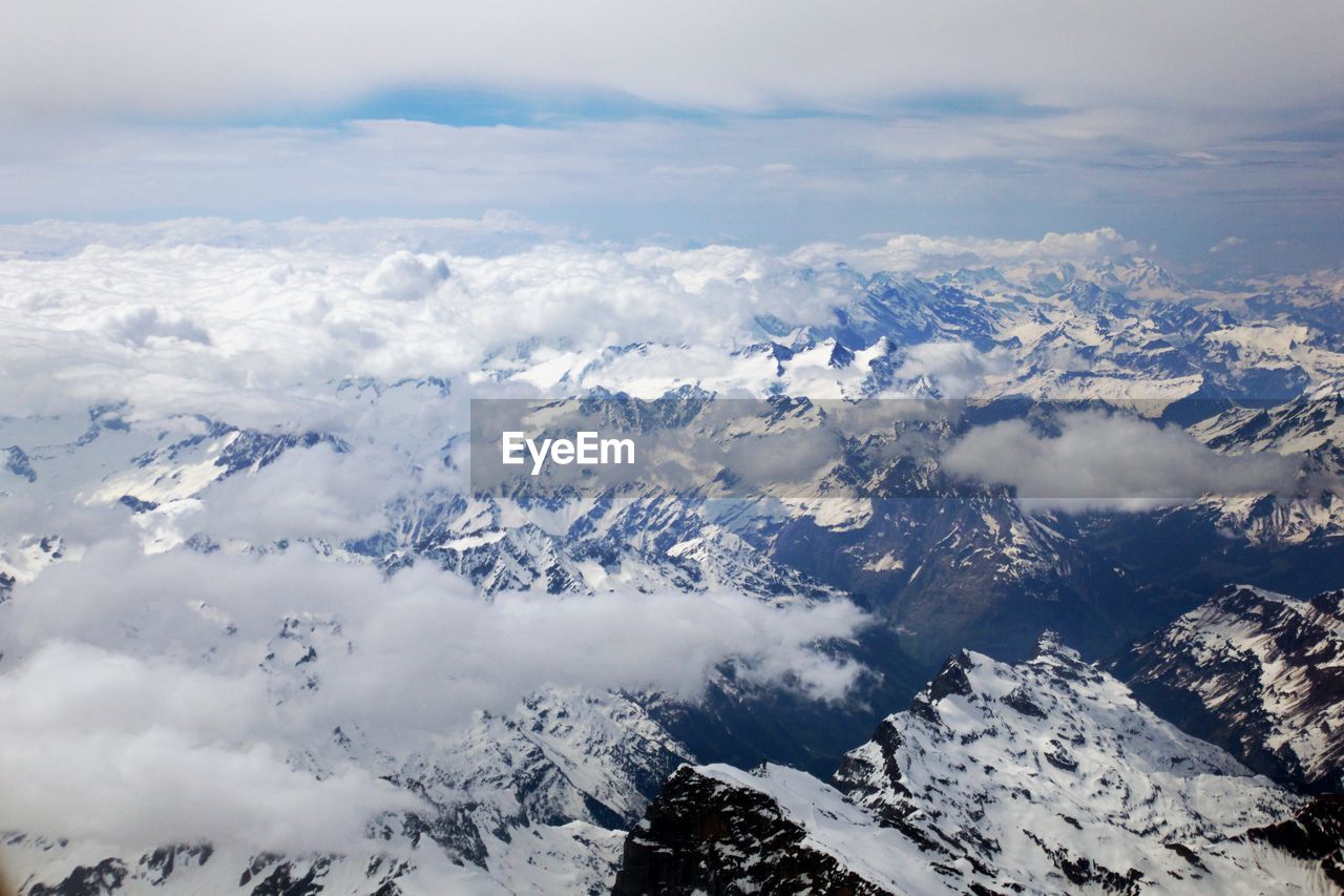 Aerial view of snowcapped mountains against sky