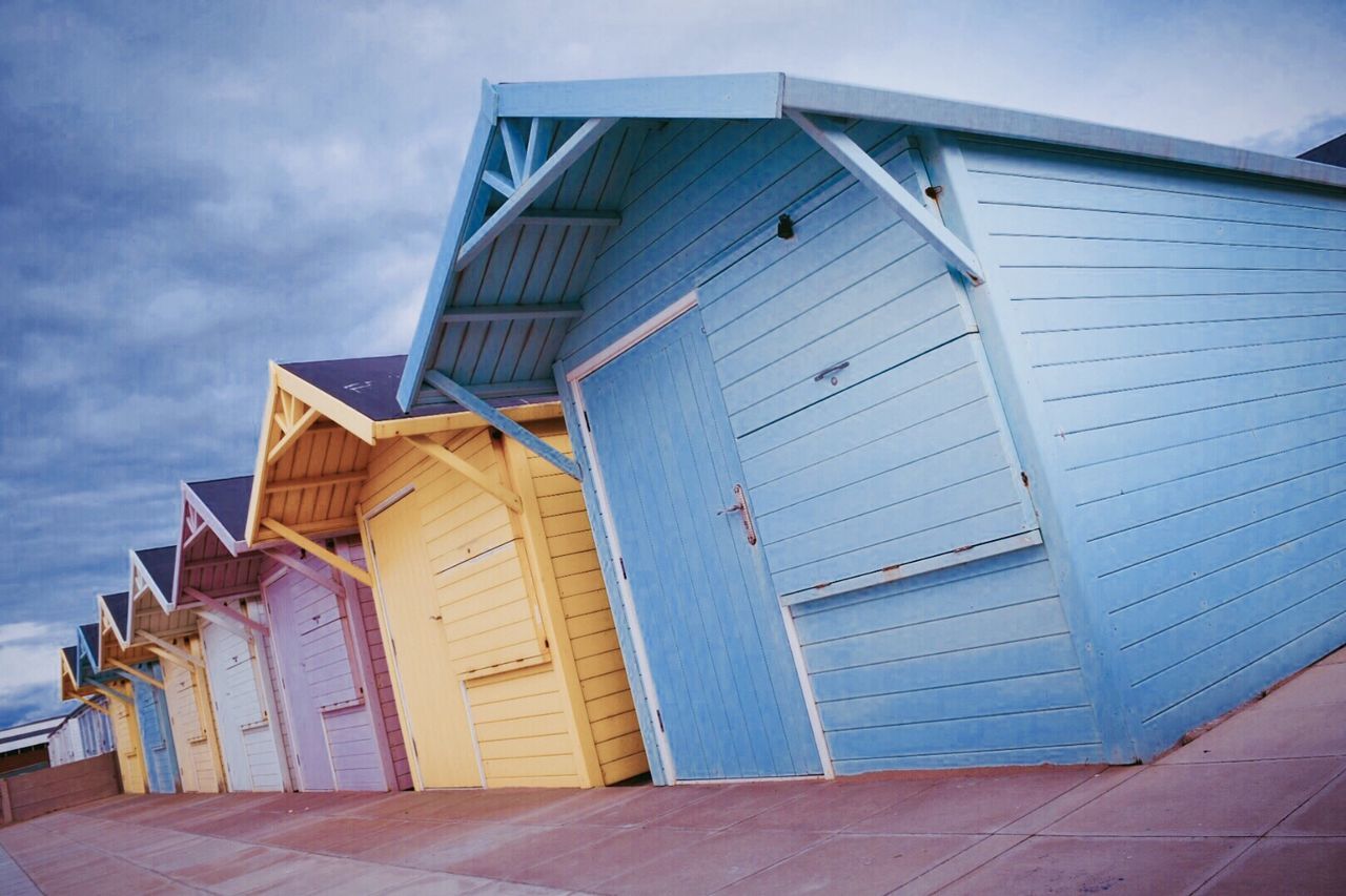 Colorful beach huts against sky