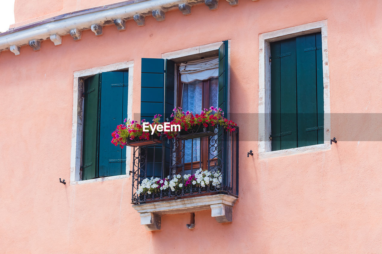 Cute balcony with flowers in pots in venice