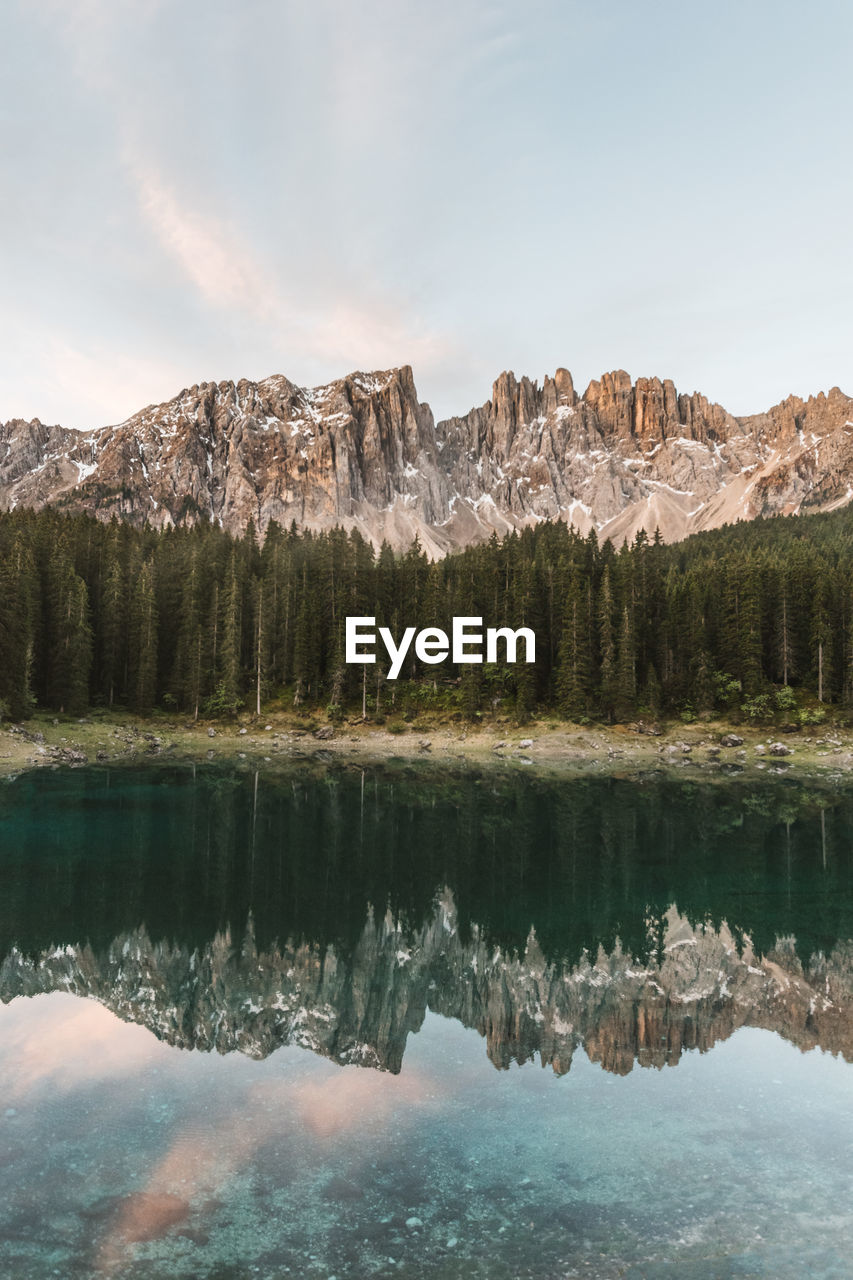 Scenic view of lake by mountains against sky