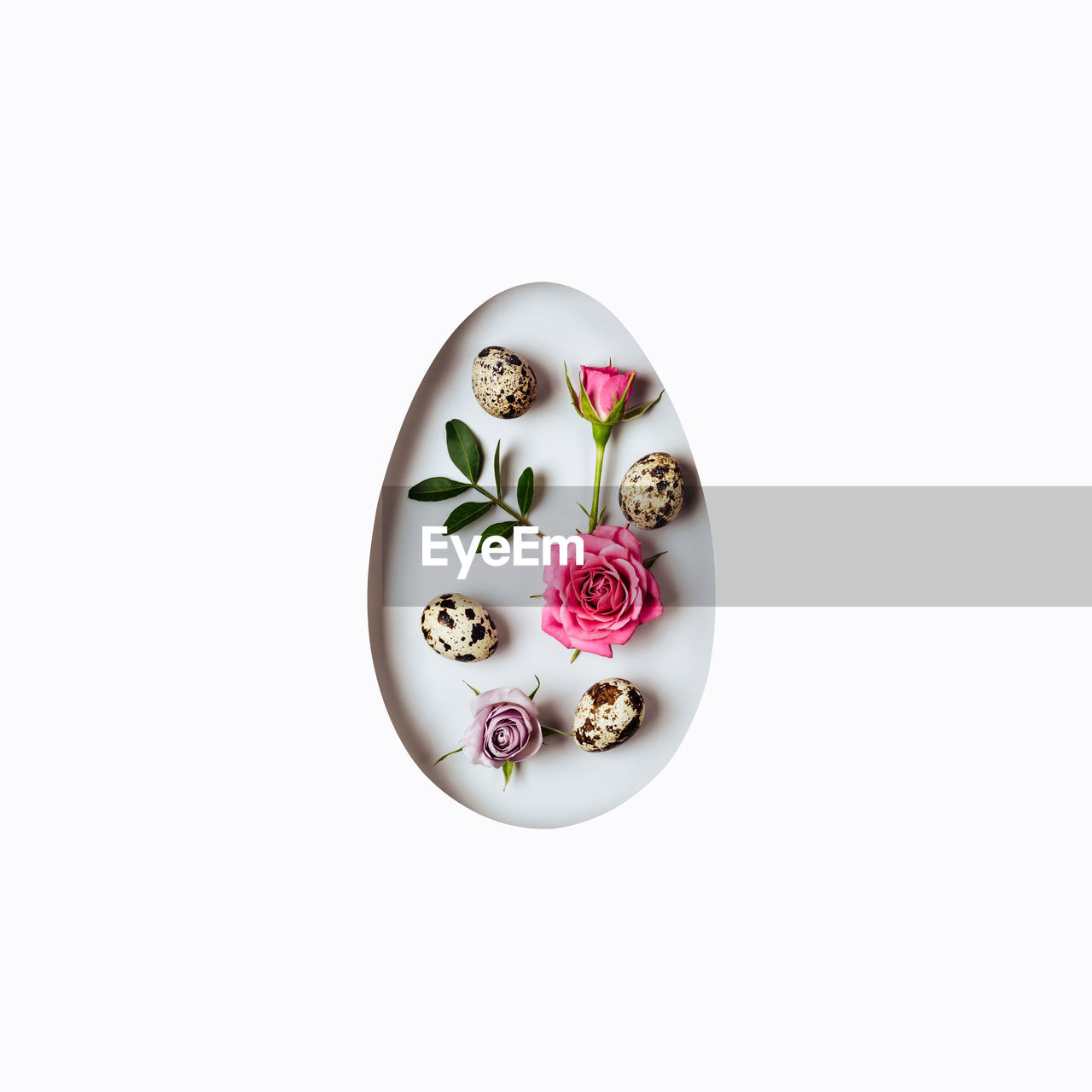 Creative layout egg made of pink flowers and green leaves. happy easter card.