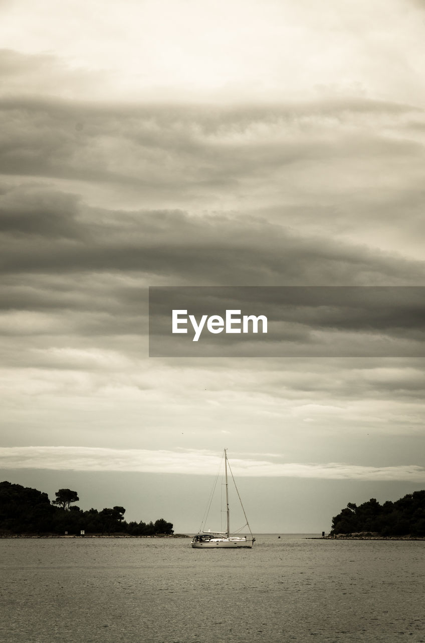 SAILBOAT IN SEA AGAINST SKY