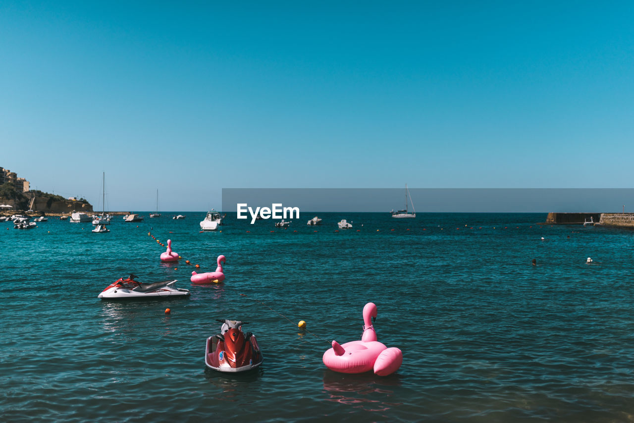 VIEW OF BOATS IN SEA AGAINST CLEAR SKY