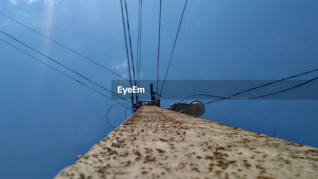 Low angle view of telephone pole against sky