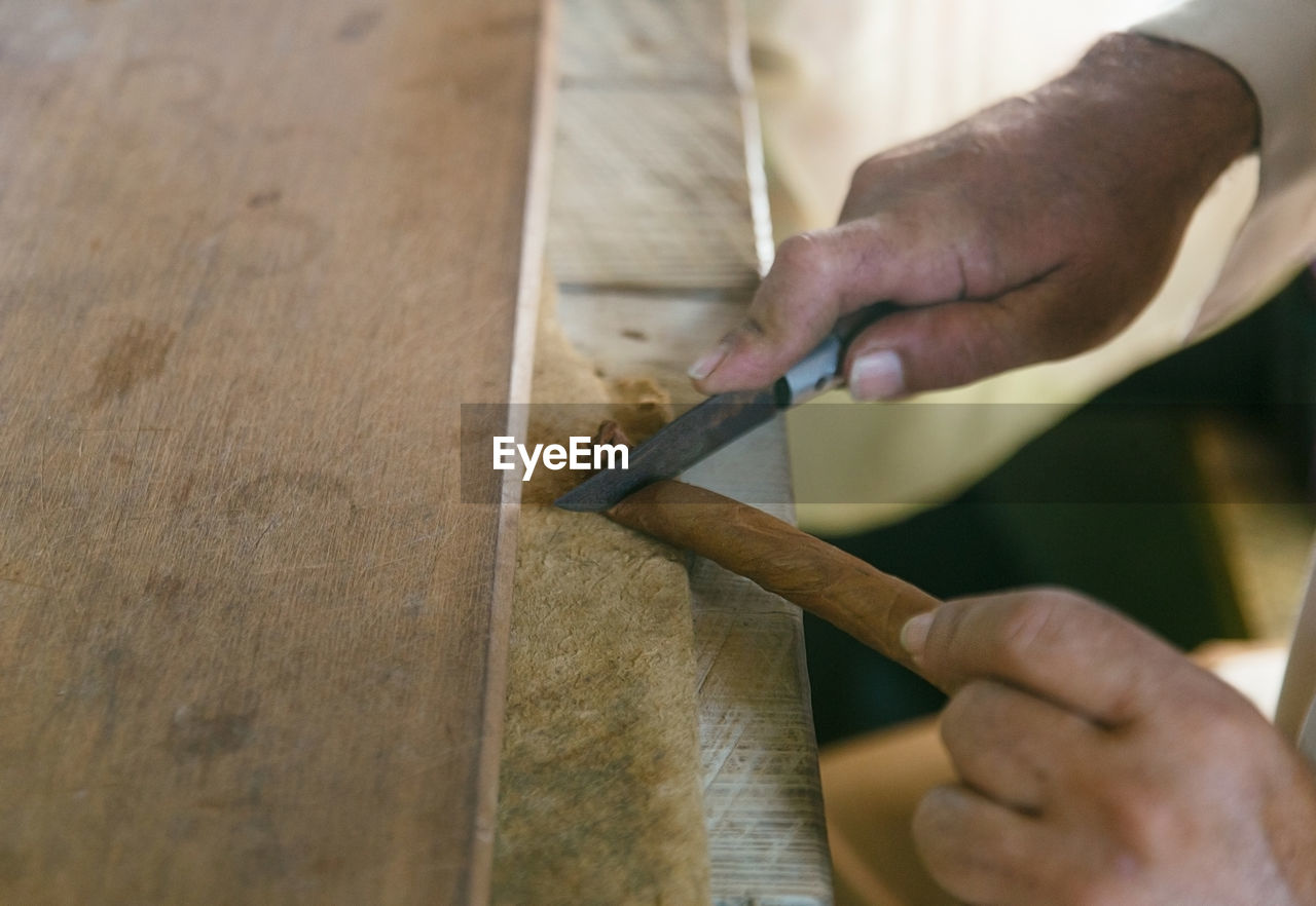 Cropped hands of person working at workshop