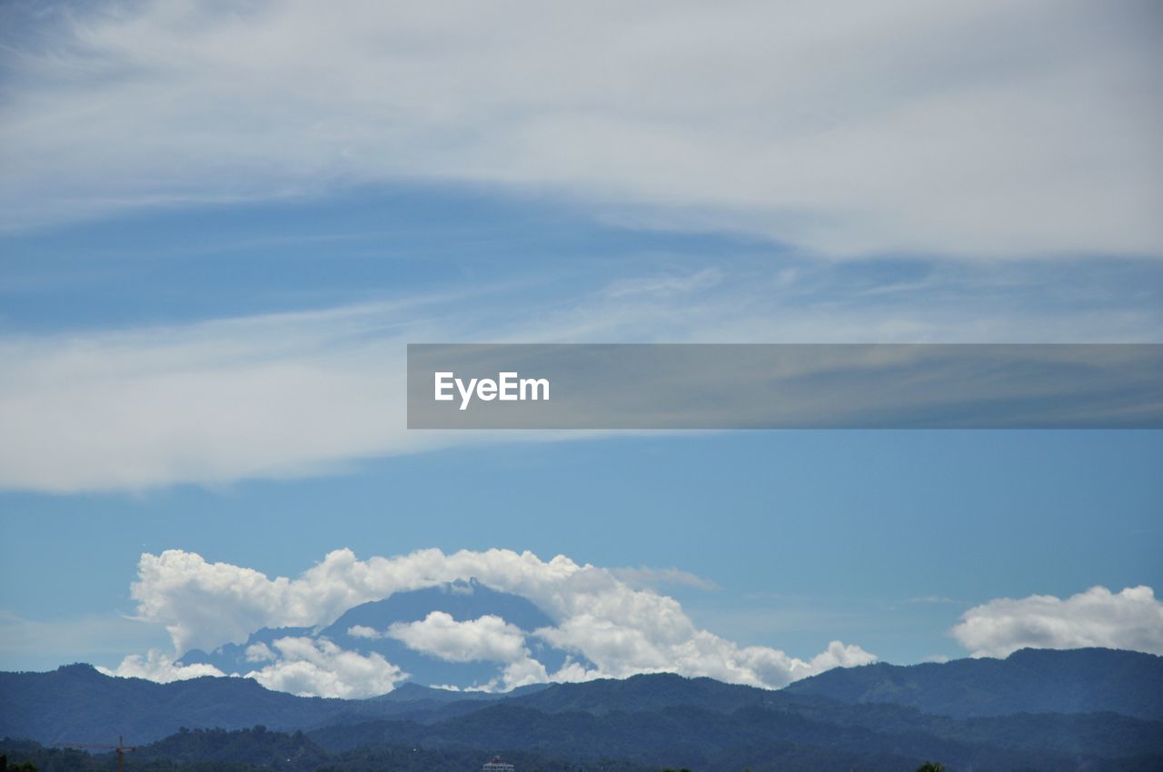 Scenic view of mountains against blue sky