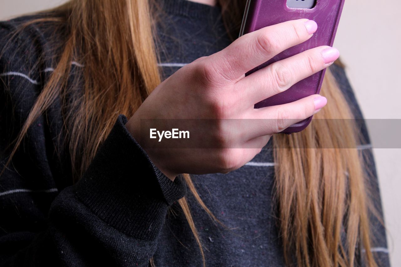 Midsection of woman using mobile phone