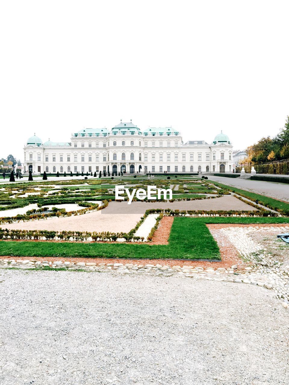 Government building and garden against clear sky