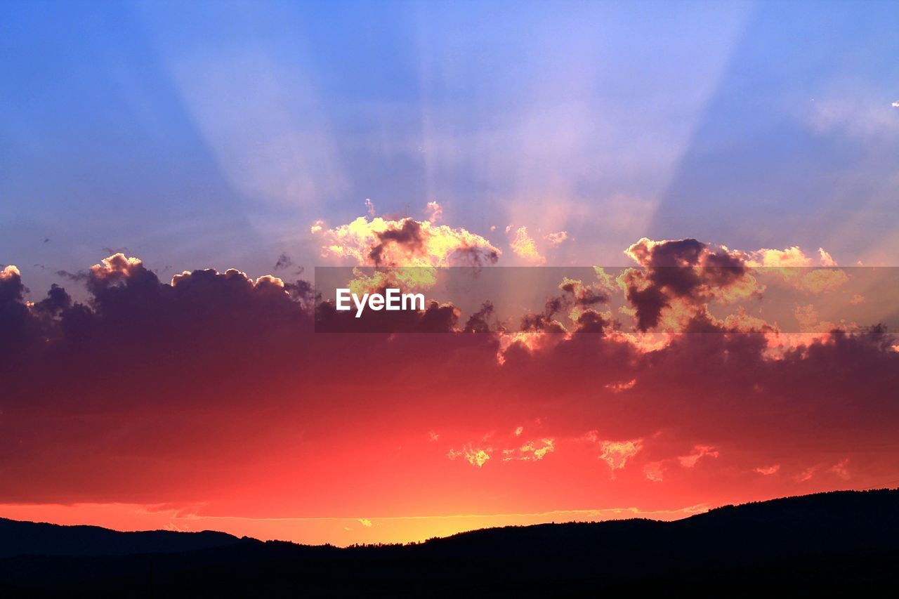 SCENIC VIEW OF SILHOUETTE MOUNTAINS AGAINST ROMANTIC SKY