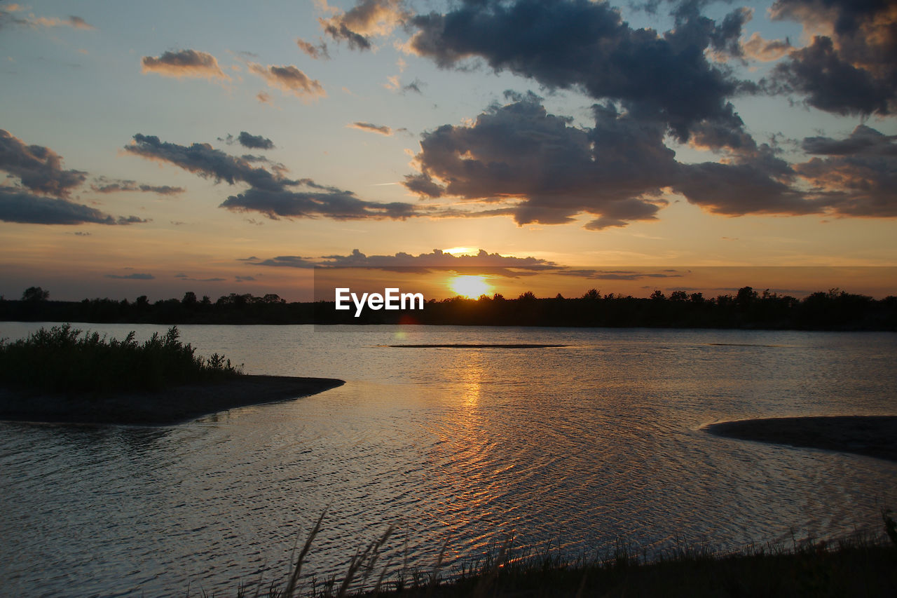 SCENIC VIEW OF LAKE AGAINST ORANGE SKY DURING SUNSET