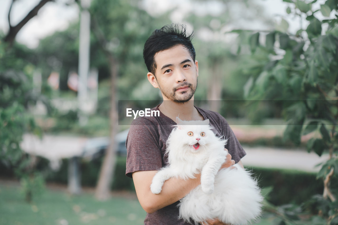 Portrait of young man with dog