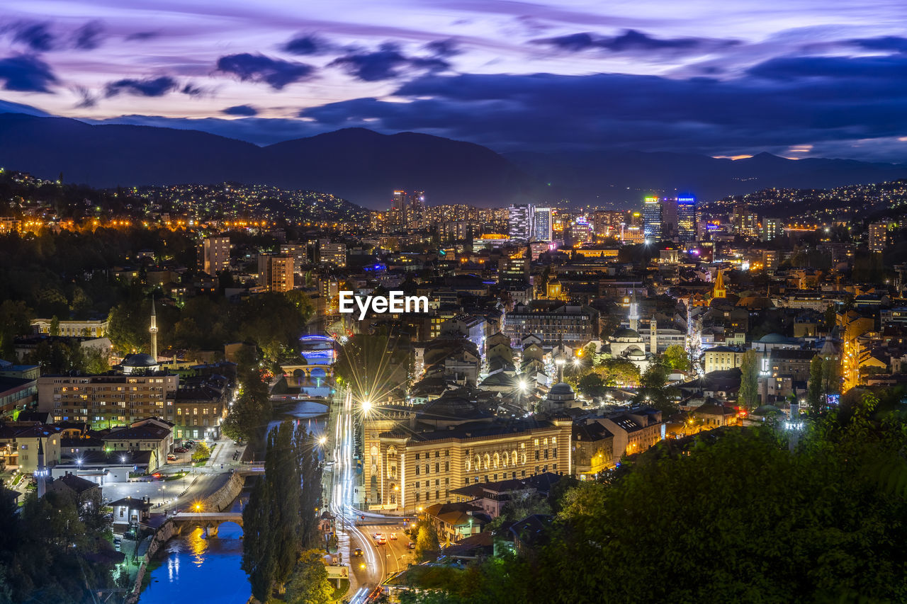 HIGH ANGLE VIEW OF CITY BUILDINGS AT NIGHT