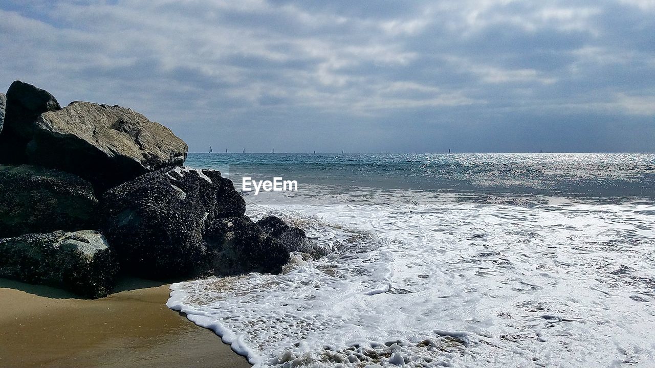 SCENIC VIEW OF SEA AND ROCKS AGAINST SKY