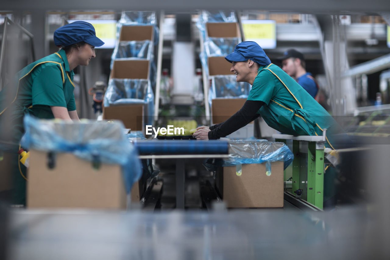 Two women working in apple factory