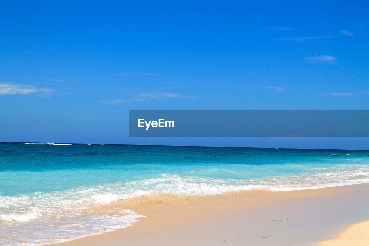 Scenic view of sea against blue sky