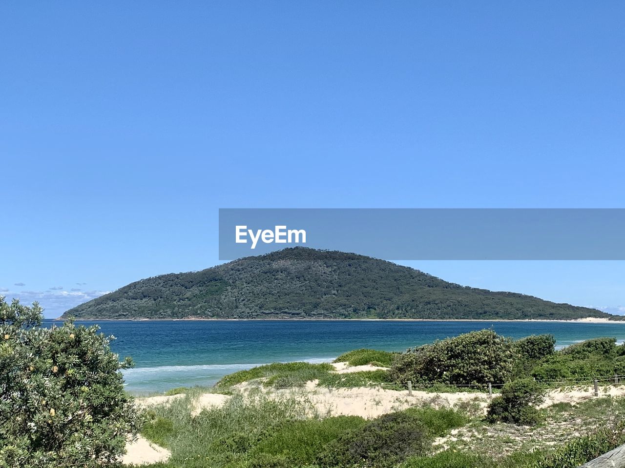 Scenic view of sea against clear blue sky