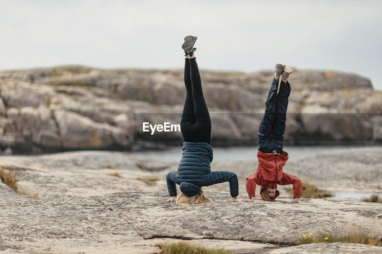 Mother and daughter doing handstand