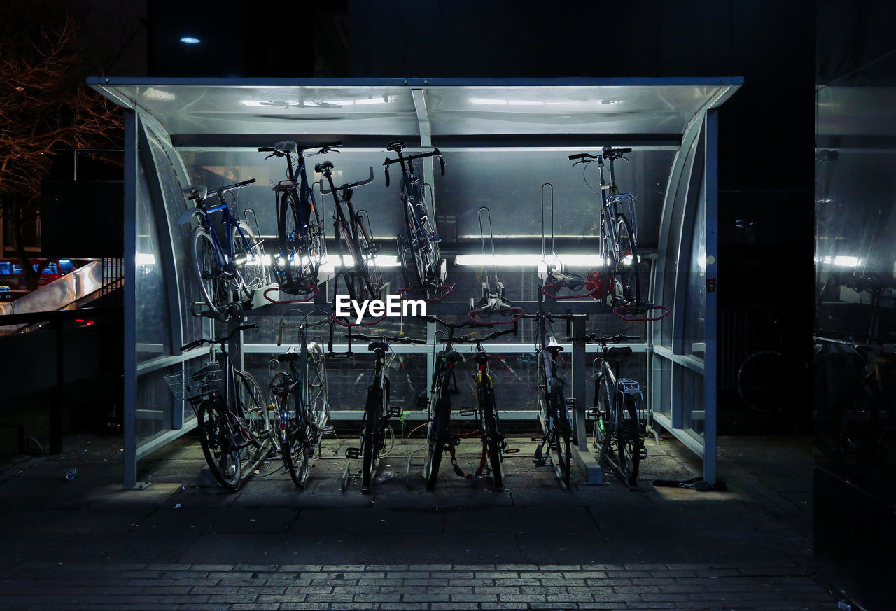 Bicycles in illuminated parking lot at night