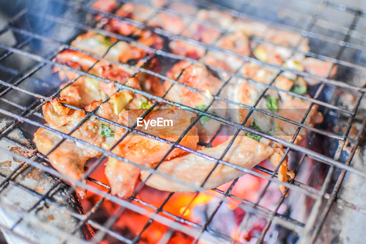 High angle view of meat on barbecue grill