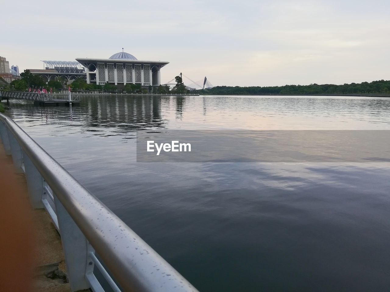 Lake by building against sky