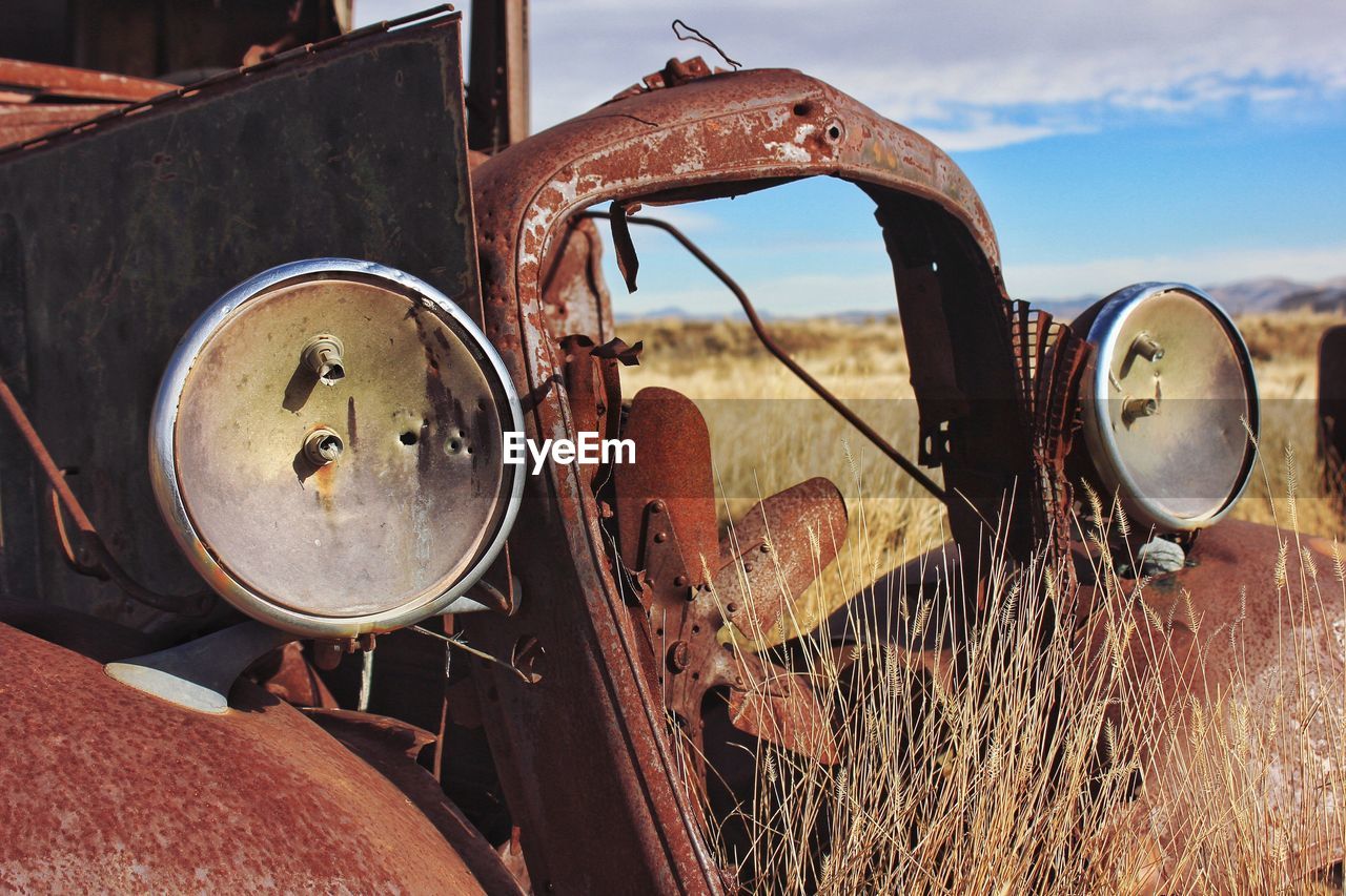 Close-up of abandoned truck on field