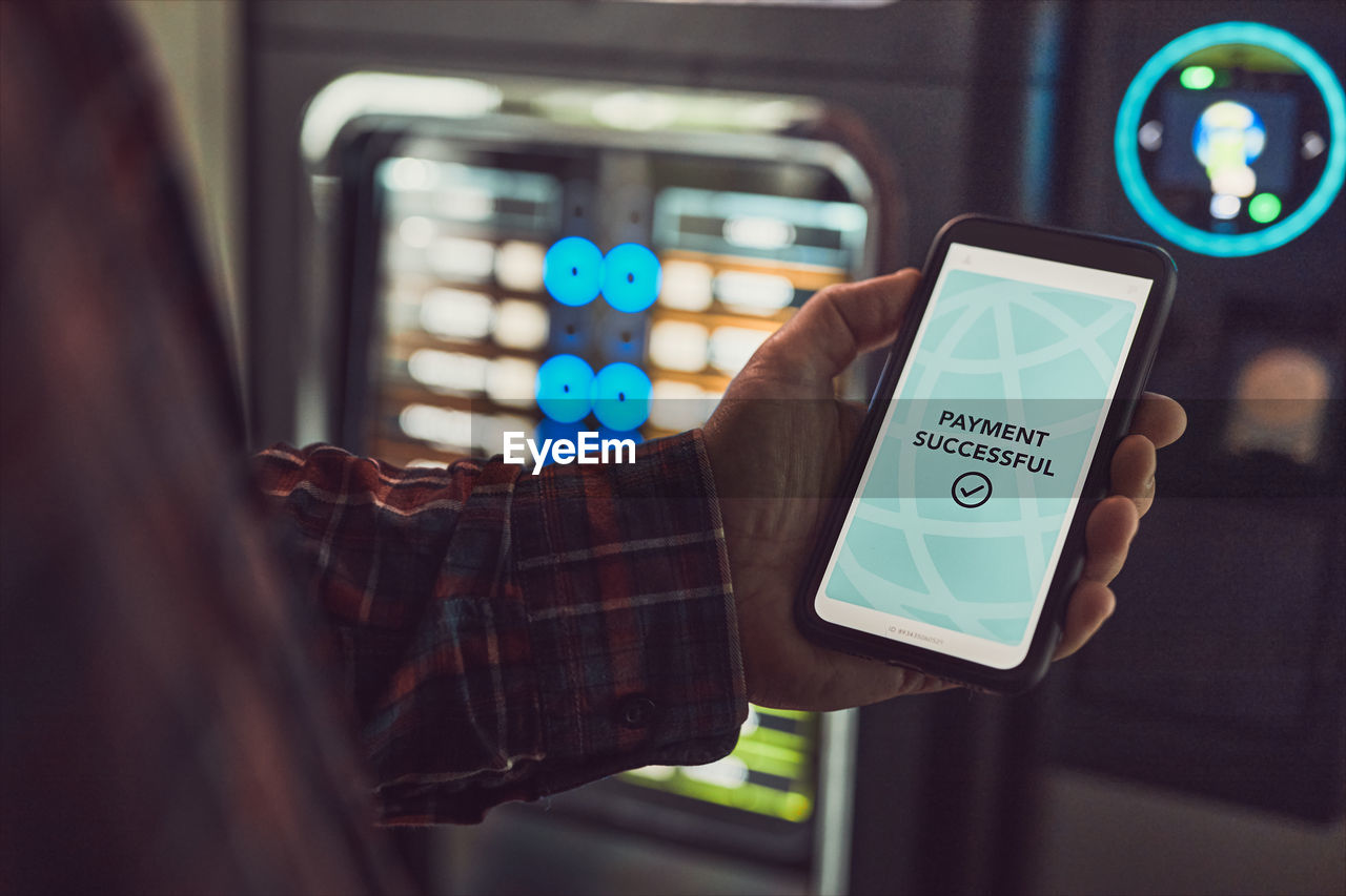 Consumer paying for product at vending machine using contactless method of payment with mobile phone