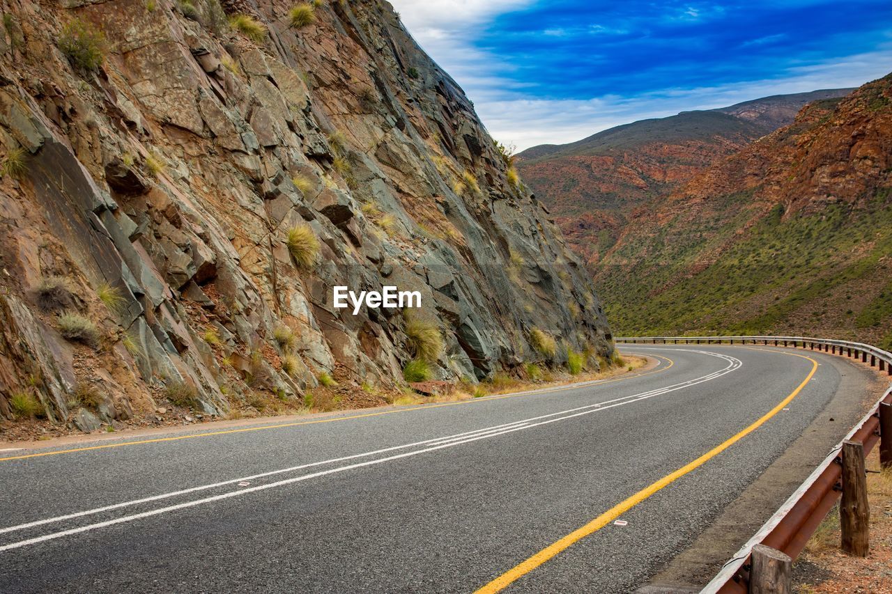 Empty road passing through mountains