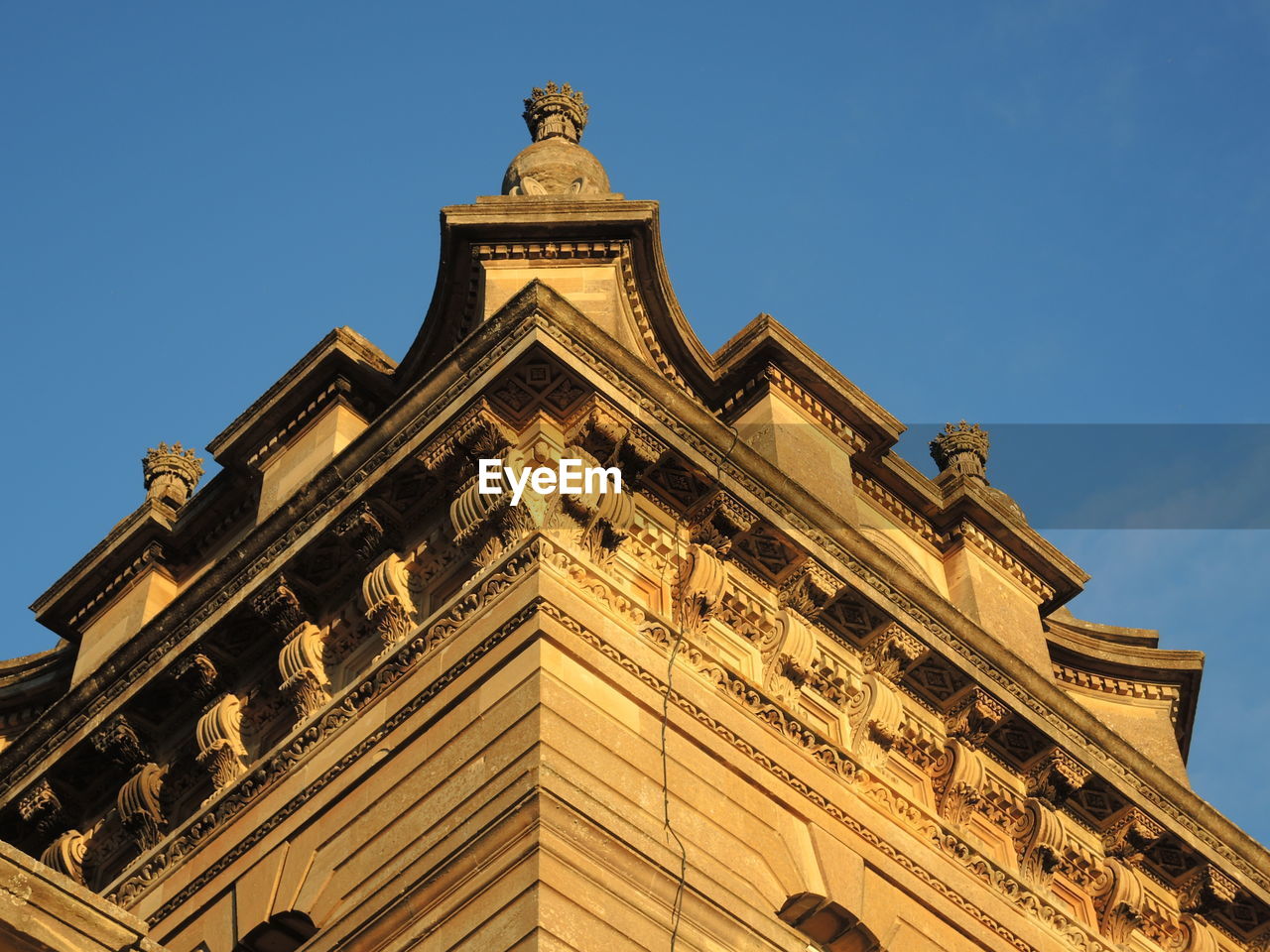 Low angle view of building against clear blue sky