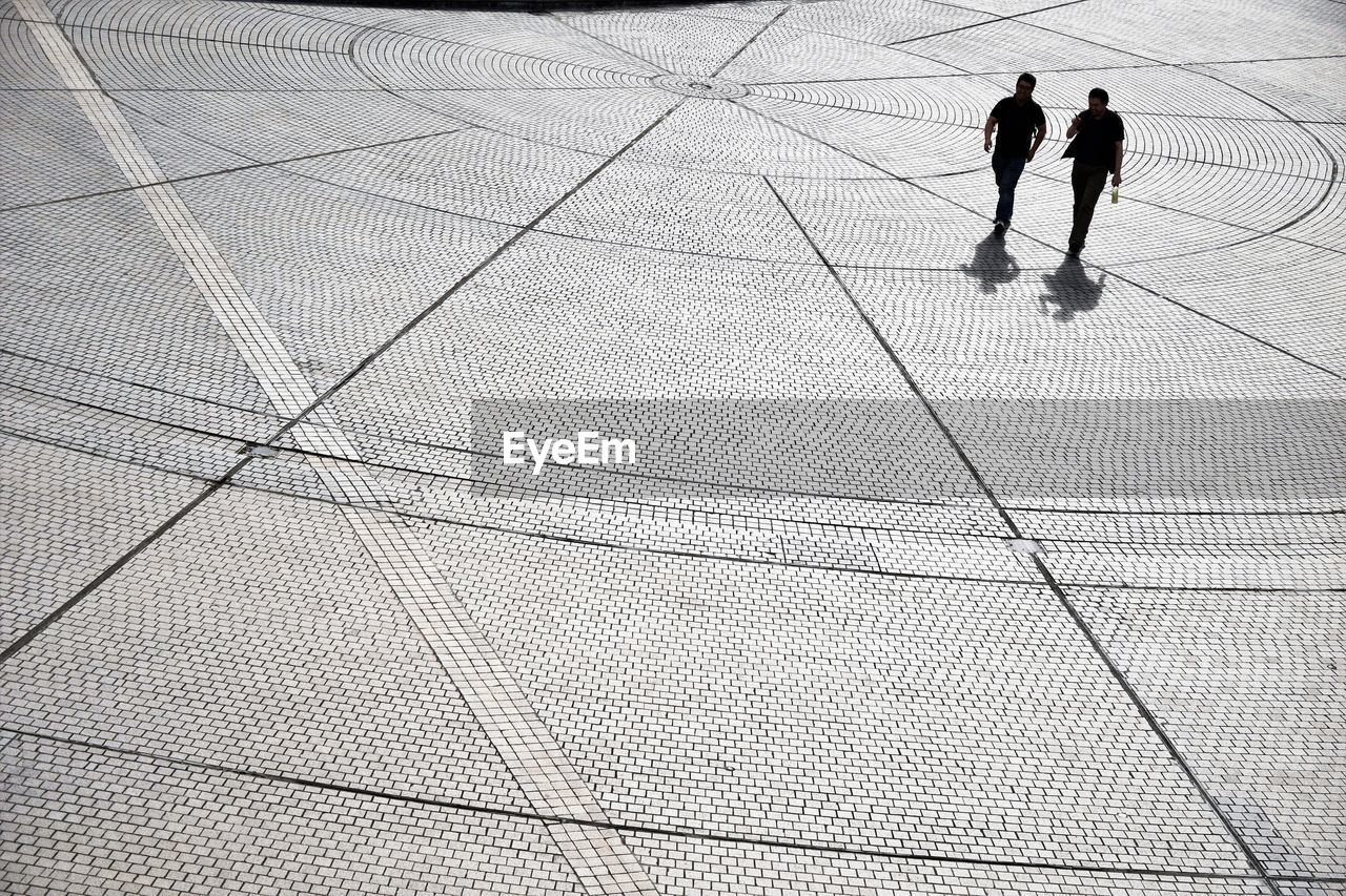 High angle view of men walking on street