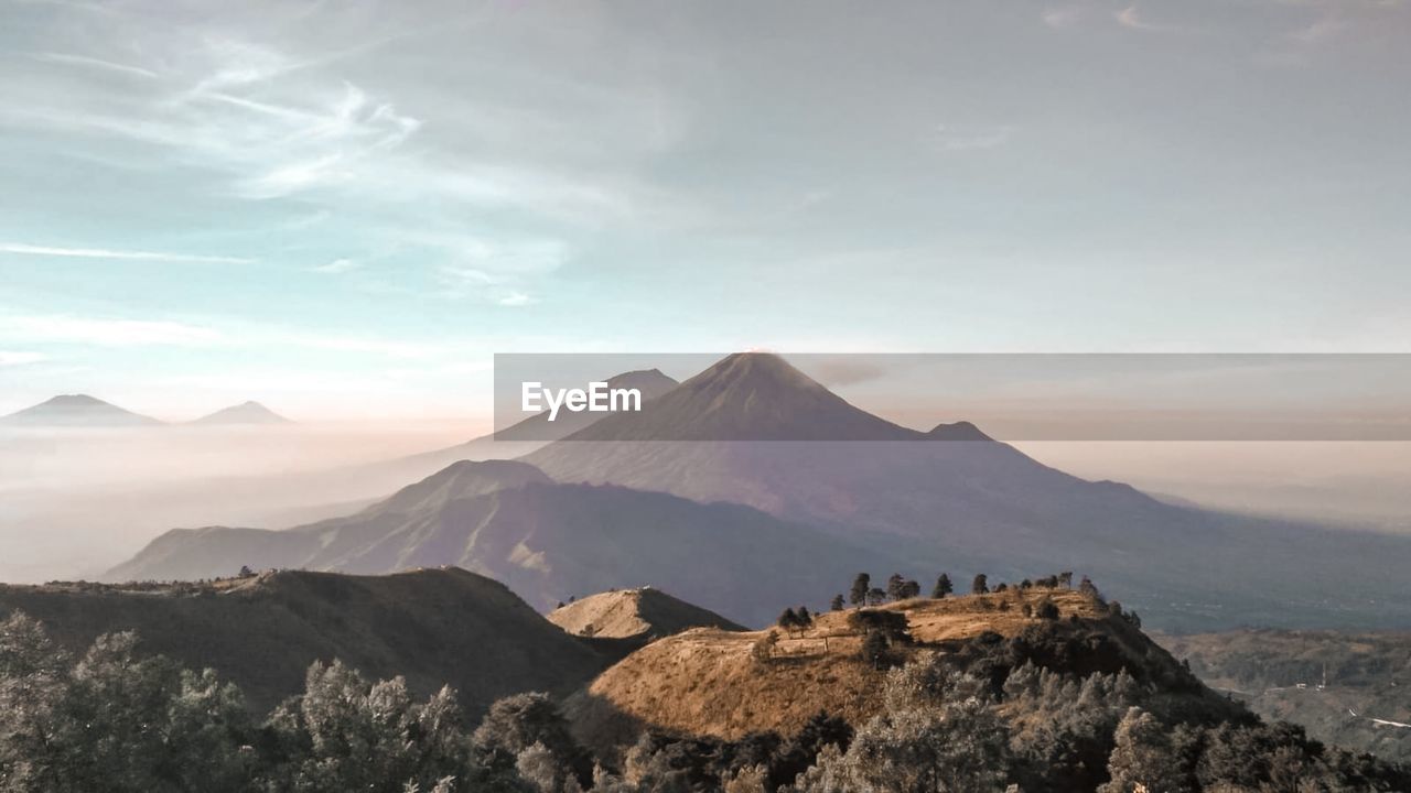 Scenic view of mountains against cloudy sky