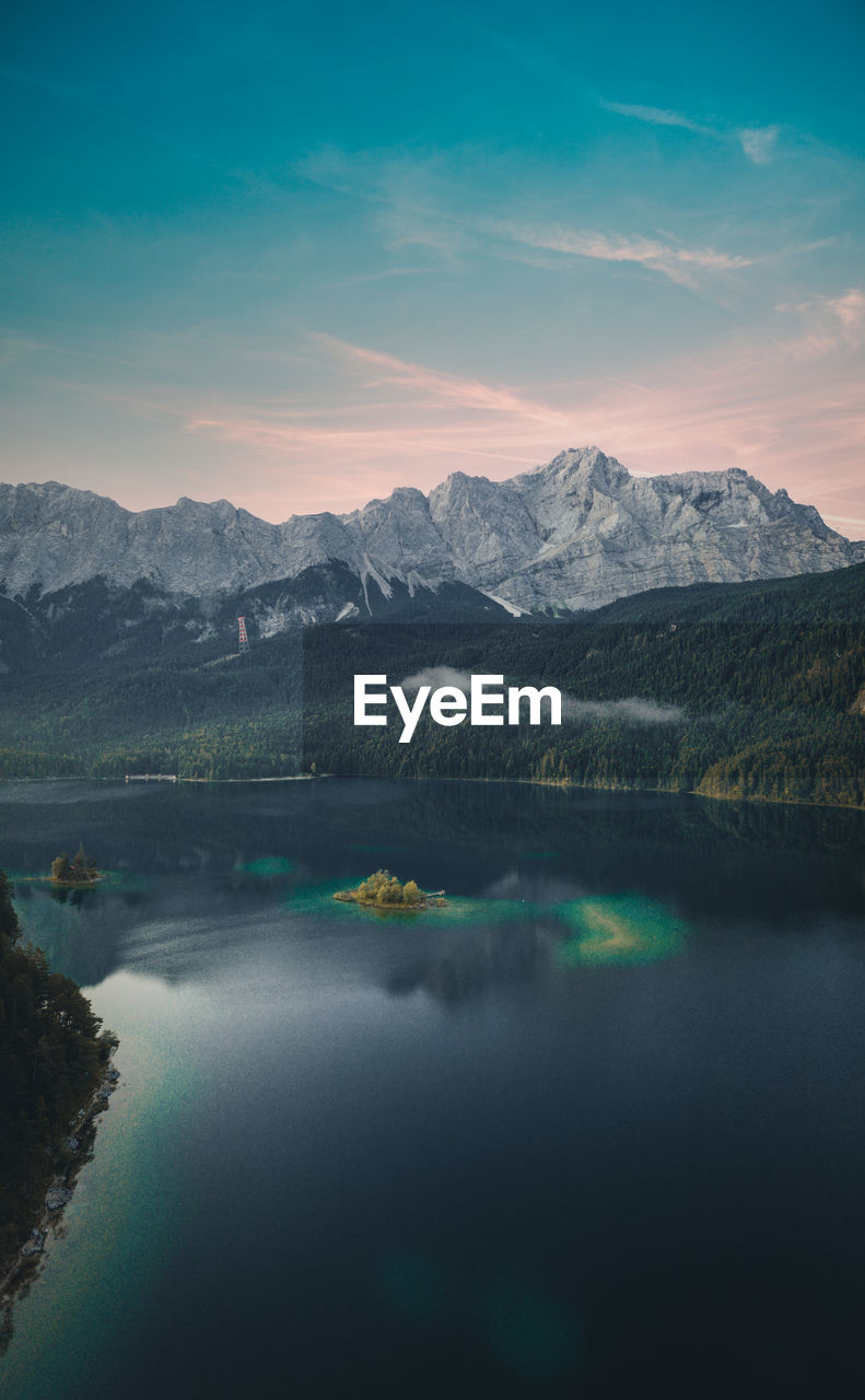 High angle view over lake eibsee with zugspitze mountains in background during sunset