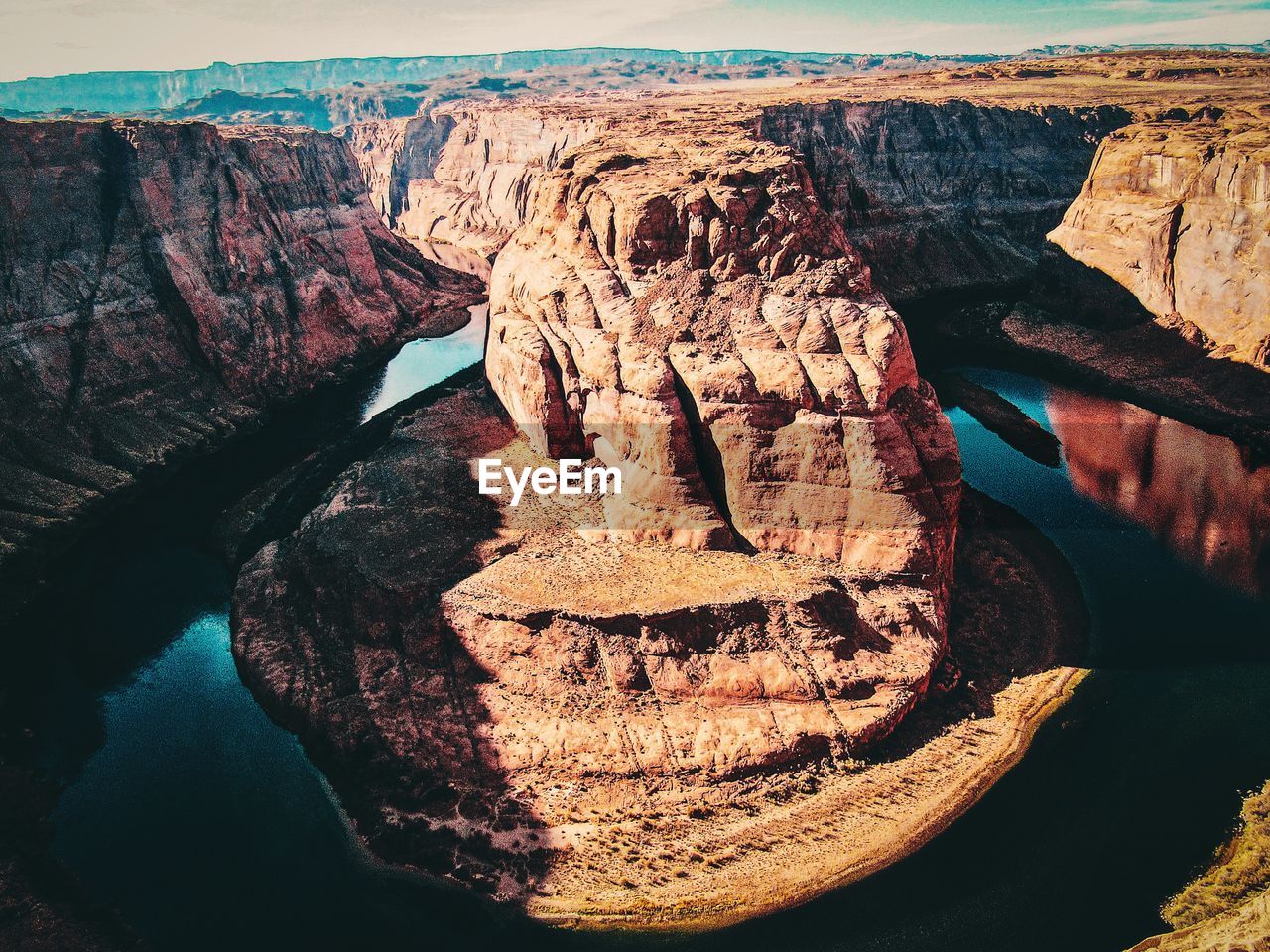 HIGH ANGLE VIEW OF ROCK FORMATIONS AT SHORE