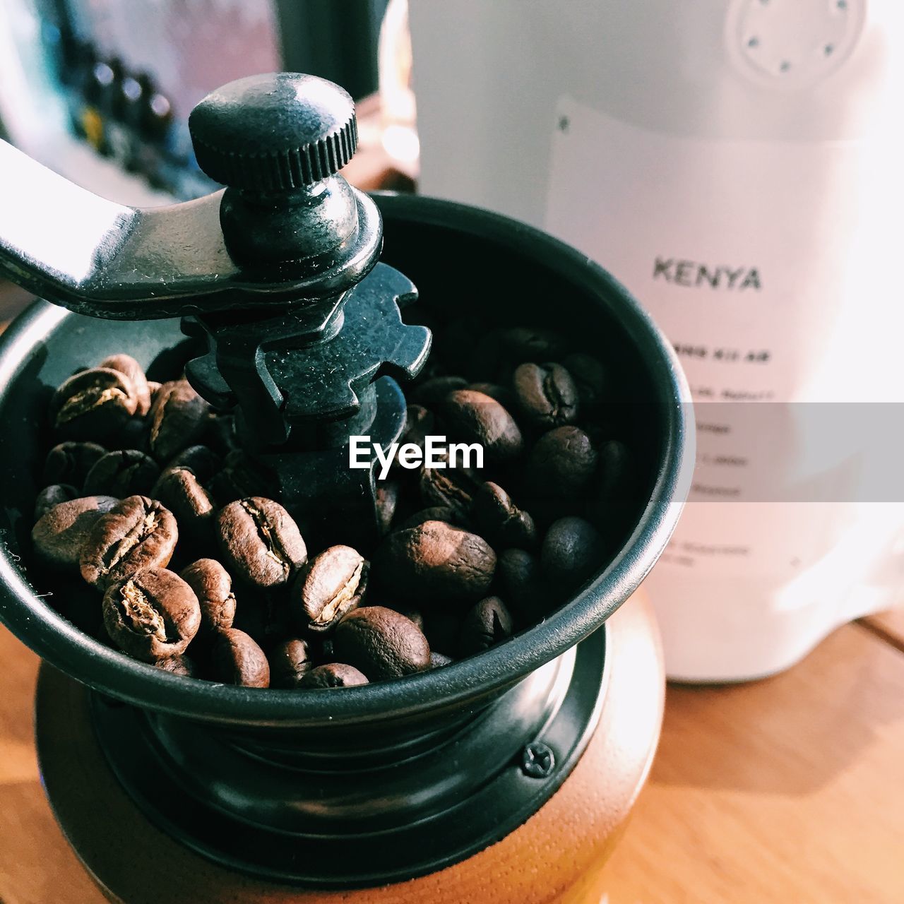 High angle view of roasted coffee beans in grinder on table