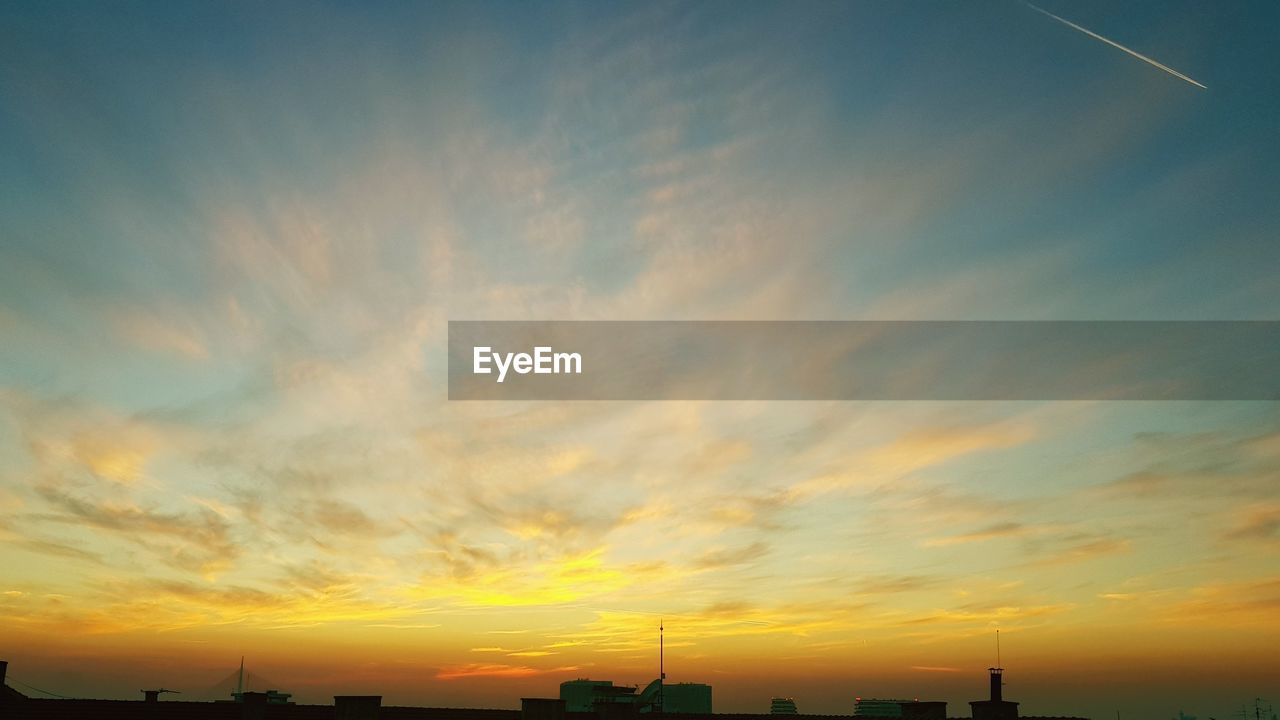 Low angle view of silhouette buildings against sky during sunset