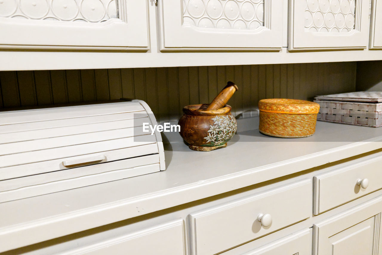 Colored knacks on the top of a vintage provencal style gray sideboard