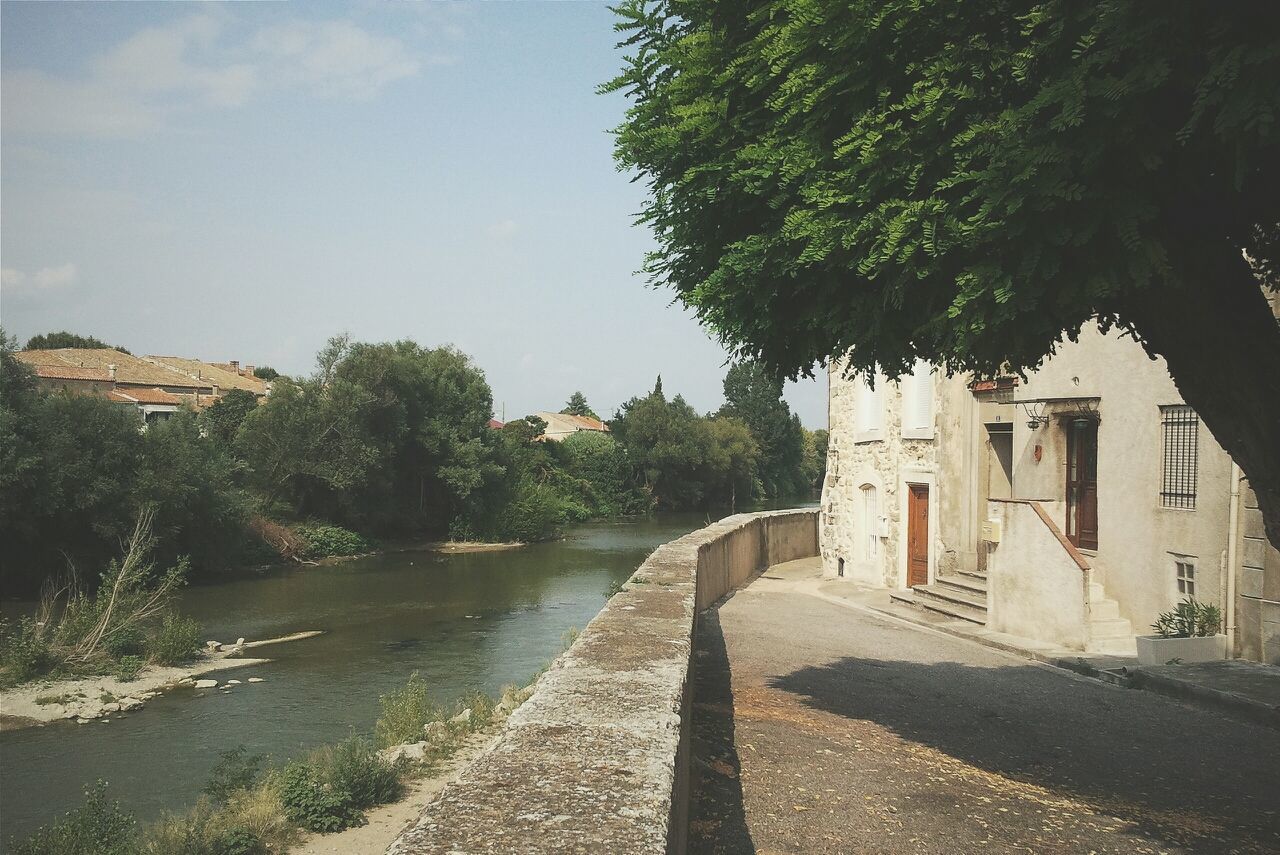 Building by river against sky