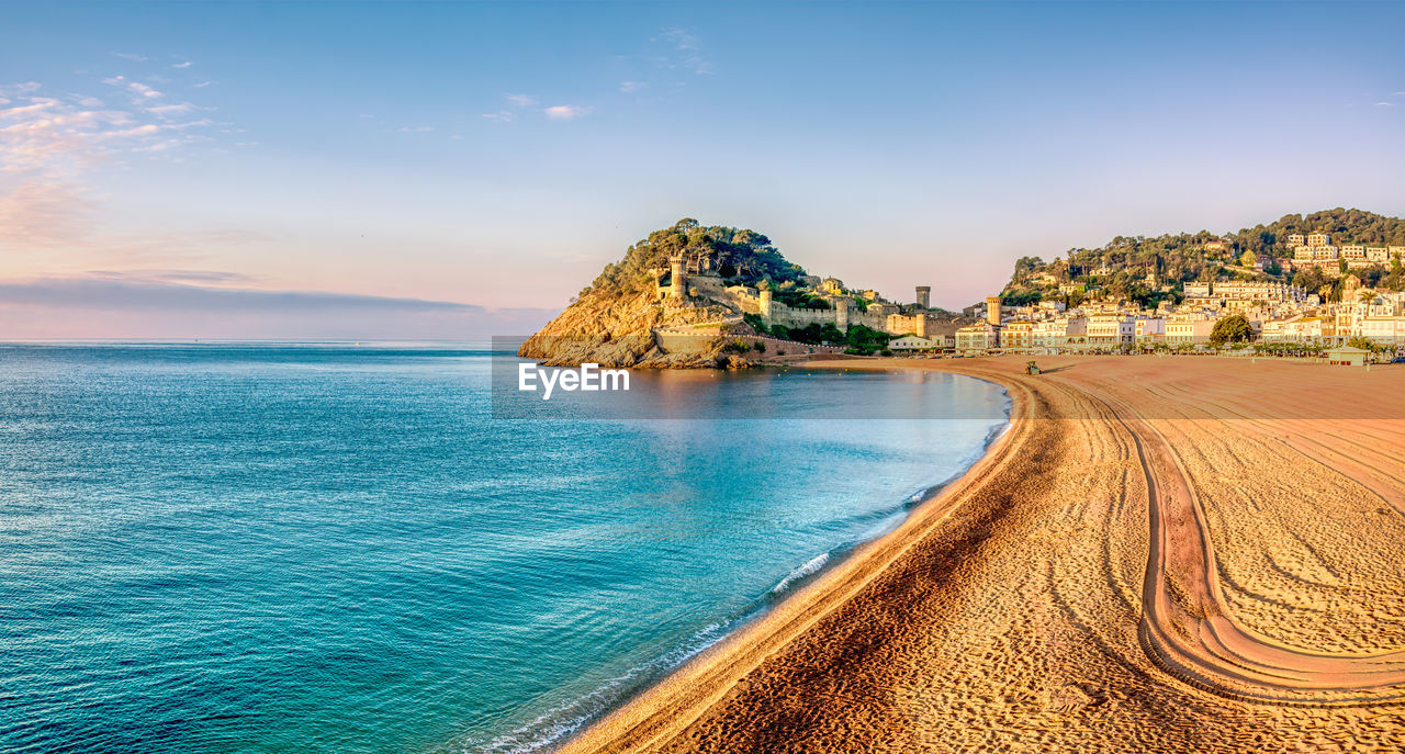 Scenic view of sea against sky . early morning at beach of lloret de mar, spain.