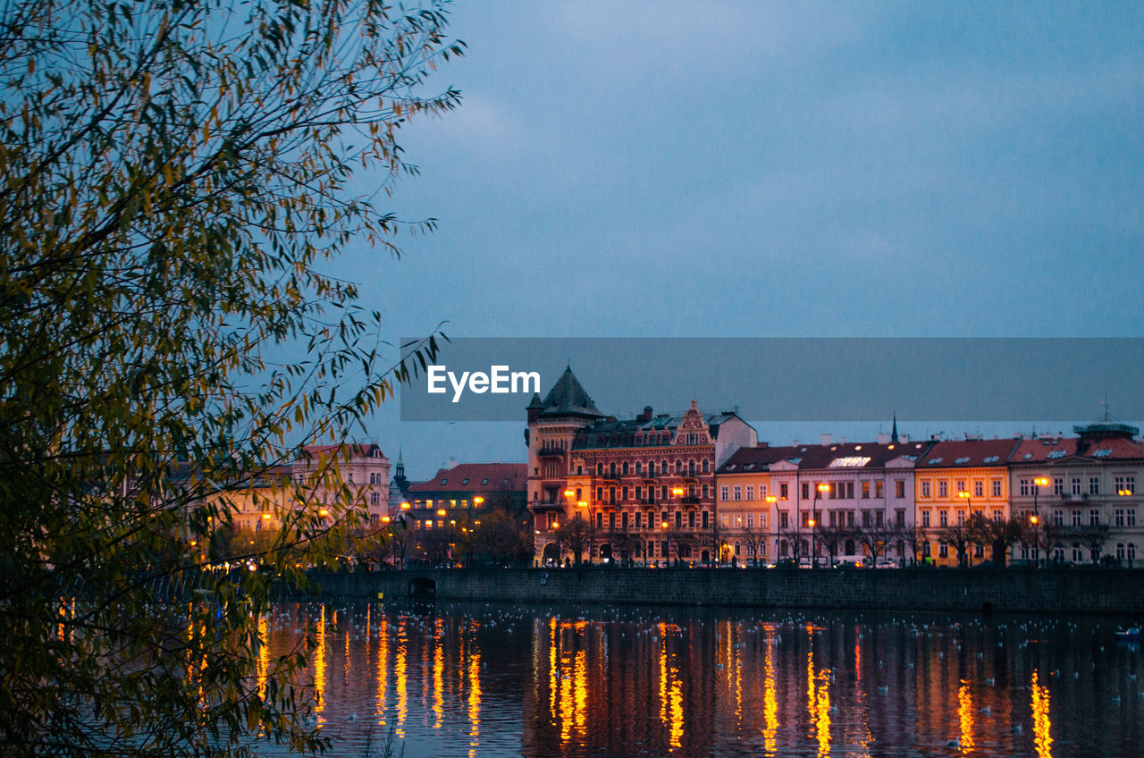 An early evening in prague during autumn with incandescent lights illuminating the city.