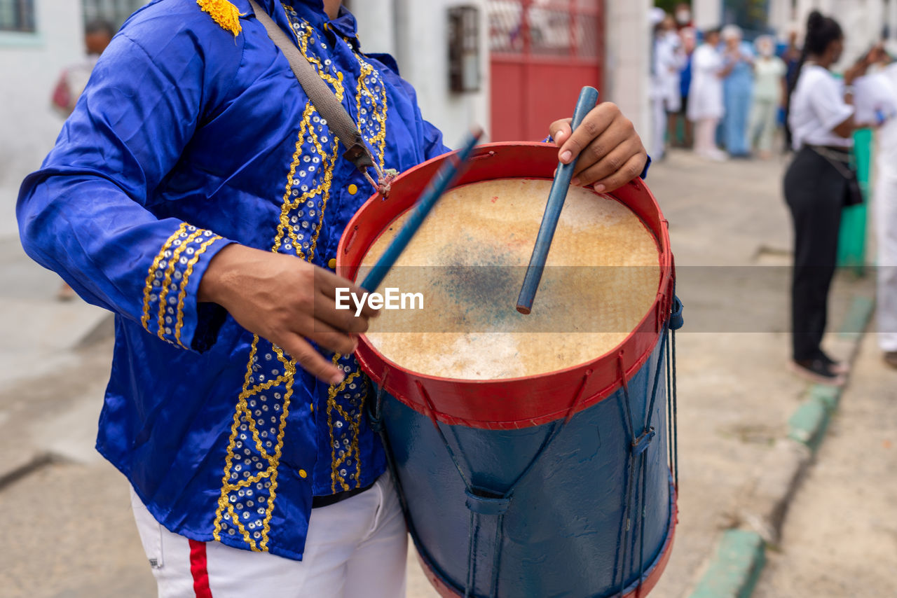 Members of a marujada, play percussion instruments during a parade at the chegancas meeting 