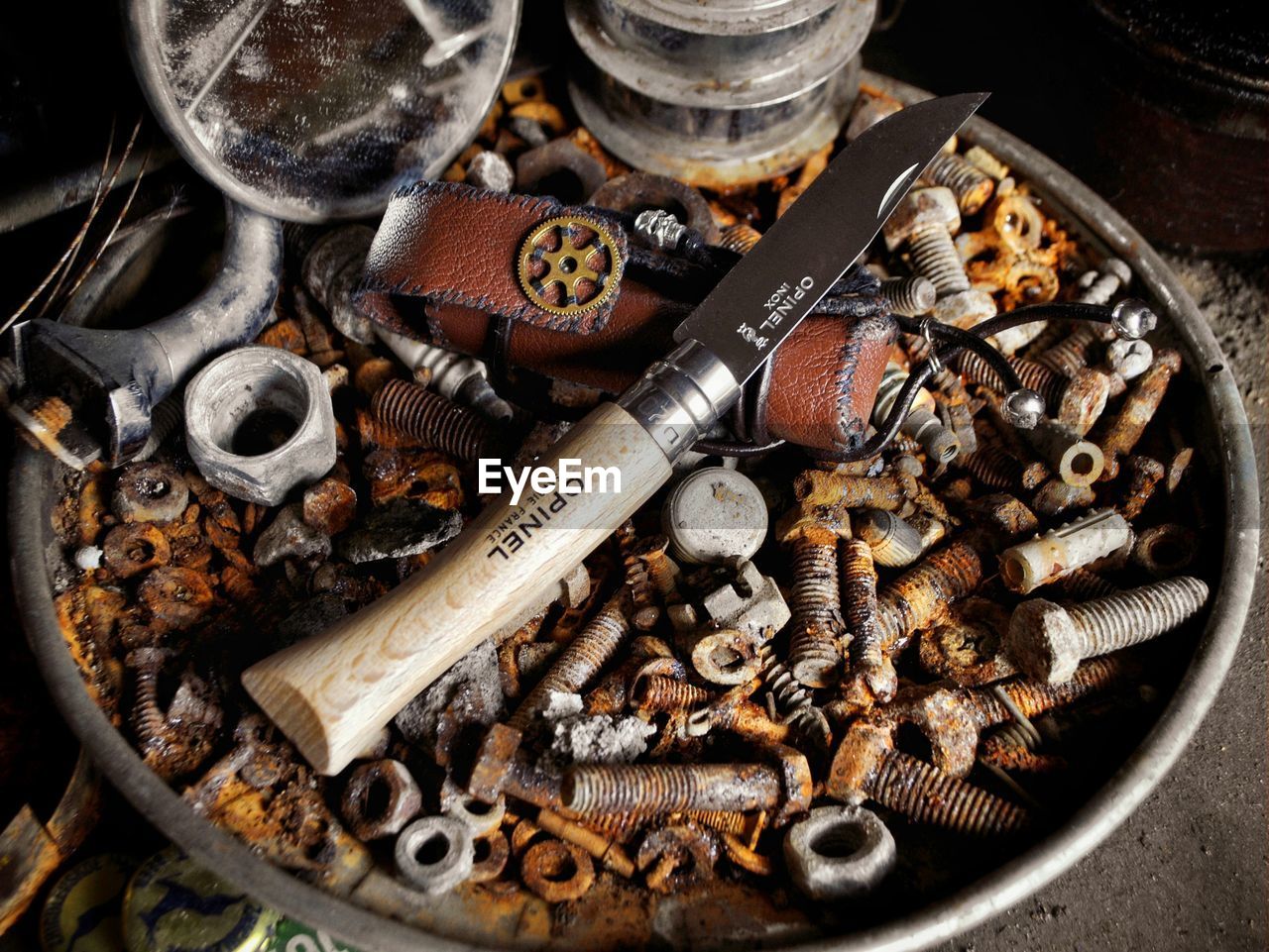 HIGH ANGLE VIEW OF OLD METAL CONTAINER ON TABLE