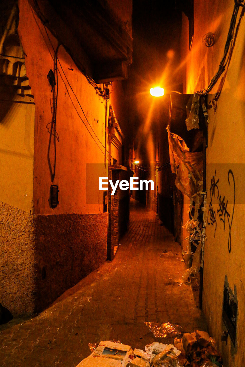 ILLUMINATED STREET AMIDST BUILDINGS